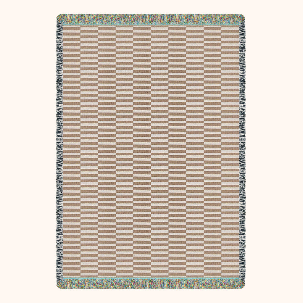 Rectangular woven blanket with a striped pattern on a white background